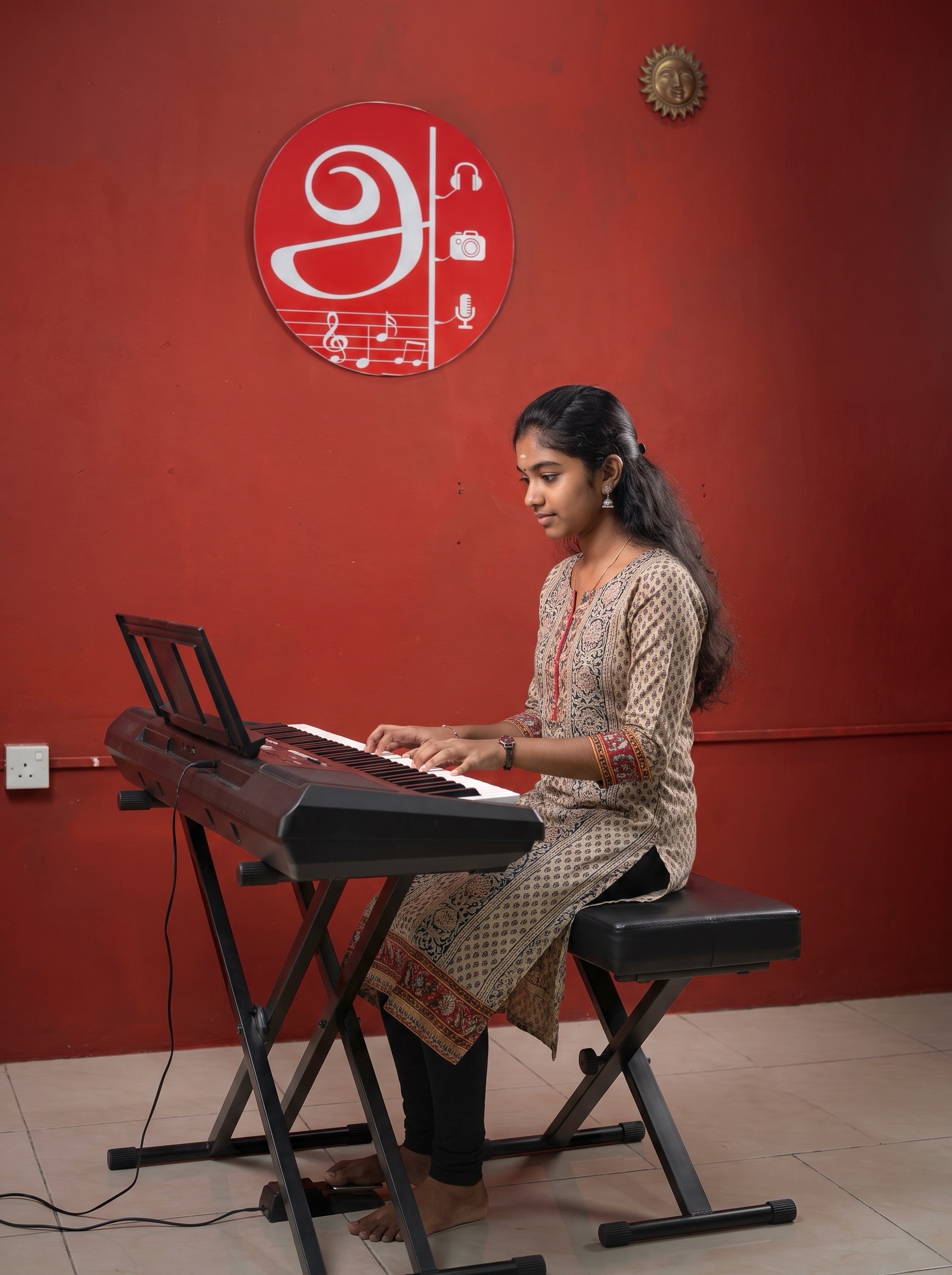 Student learning digital piano at AANA Academy